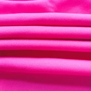 Detailed macro view of bright pink elastic knit fabric texture and soft material folds
