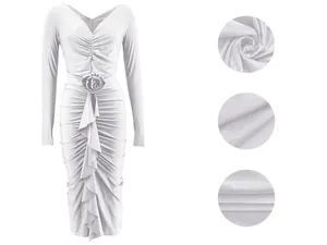 Close-up of the pleated white fabric and draped rose detail on the elegant V-neck dress.