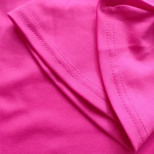 Detailed macro view showing the high-quality stitching and pink fabric texture of the garment