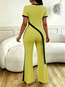 Back view of neon green two-piece set with contrast black diagonal cut and wide-leg pants