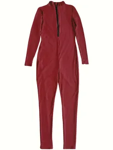 Detail view of the red ribbed jumpsuit with functional front zipper closure.