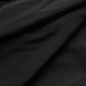 Detailed macro shot showing the fine texture and quality of the premium black dress fabric.