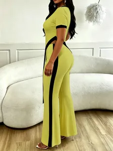 Detailed side view of lime green two-piece set with black contrast trim and flare pants