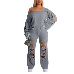 Two-piece grey distressed ripped tracksuit with off-shoulder sweatshirt and long pants