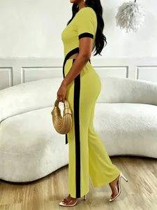 Side view of lime green two-piece set with cutout crop top and striped wide-leg pants