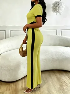 Detail of neon green rib-knit two-piece set with black side stripes on wide-leg pants