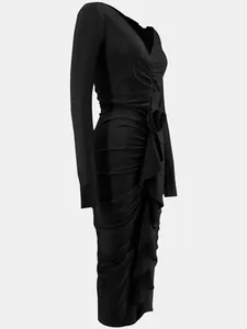 Detailed view of an elegant black ruched bodycon dress with 3D rose and V-neckline