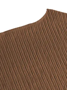 Macro detail of the brown pleated fabric texture for fashionable resort style set.