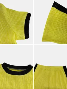 Detailed views of yellow crinkle fabric set with contrast black trim and ribbing