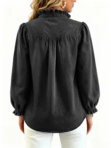 Detailed back view of a black denim shirt with ruffled collar and pleated princess sleeves