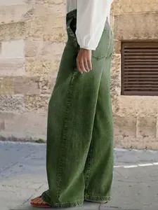 Πλαϊνή όψη του γυναικείου πλυμένου πράσινου τζιν με φαρδιά μπατζάκια και κουμπιά