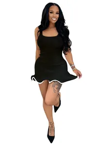 Close-up view of a black sleeveless ribbed mini dress with a white wavy ruffled hemline