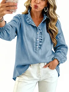 Detail view of a light blue denim shirt with ruffle collar and puff sleeves.