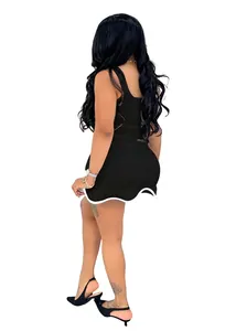 Back view detail of sleeveless slim black tank dress with white wavy scalloped hem