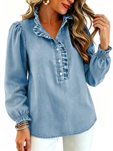 Close-up detail of light blue denim blouse featuring ruffle collar and puff sleeves