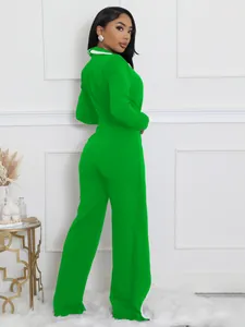 Vista trasera de un mono verde brillante de manga larga con detalle de cuello blanco