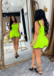 Close-up of lime green sleeveless dress with wavy ruffled hem and black trim