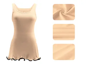 Detailed view of apricot ribbed sleeveless tank dress with contrast wavy lettuce hem