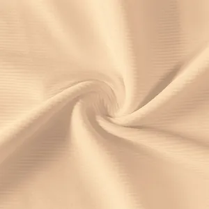Detailed macro shot of soft apricot ribbed fabric texture for summer tank dress