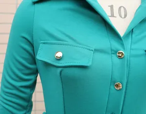 Detailed macro shot of a teal long sleeve jumpsuit showing silver buttons and collar