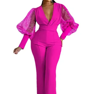 Tuta elegante fucsia a gamba larga con maniche a sbuffo in mesh scintillante e scollo a V