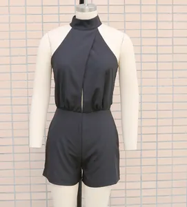Close-up front view of black halter neck sleeveless romper jumpsuit on studio mannequin