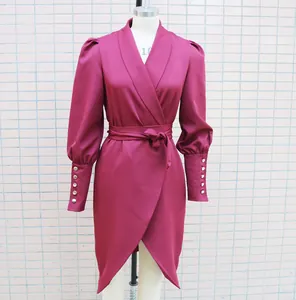 Close-up detail of fuchsia shawl collar wrap dress featuring elegant puff sleeves