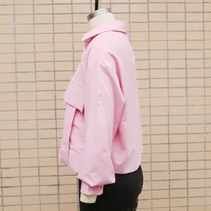 Side view detail of a stylish pink loose batwing sleeve shirt featuring large chest pockets