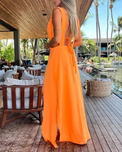 Detailed back view of orange two-piece vacation dress set featuring tie-up open back