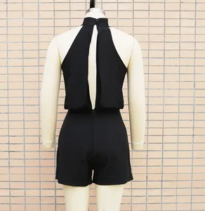 Back view of a black halter neck sleeveless romper with cutout detail on mannequin
