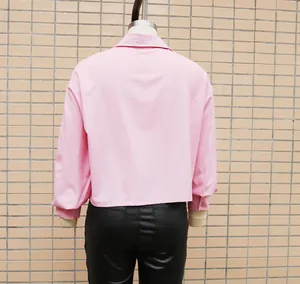 Back view of a pink loose-fitting batwing sleeve shirt for women styled with black trousers