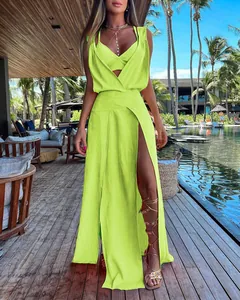 Neon lime green two-piece resort maxi dress set featuring a bra top and high slit skirt