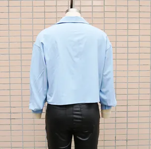 Detailed back view of a light blue loose batwing sleeve shirt for women's office wear