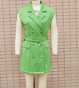 Detail showing the belted waist and double-breasted front of the green blazer dress.