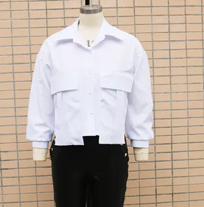 Close-up detail of loose white batwing sleeve shirt for women with chest pockets.