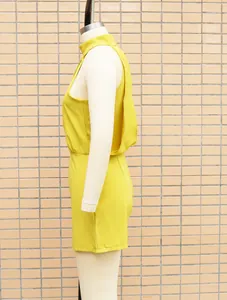 Detailed side view of a vibrant yellow high-neck sleeveless romper displayed on a mannequin