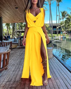 Detail of a bright yellow two-piece vacation dress set with a high slit skirt.