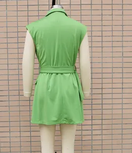 Back view of a green sleeveless office dress with a waist belt and lapel collar