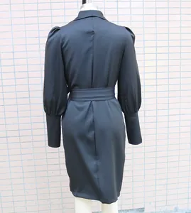 Detailed back view of a black long-sleeved dress with shawl collar and adjustable waist tie