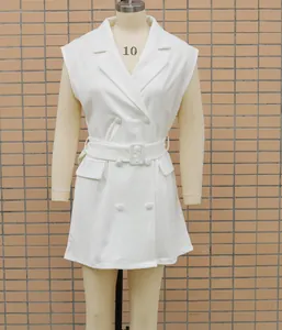 Detailed view of a white sleeveless blazer dress with double-breasted buttons and belt