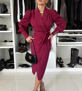 Detailed view of a luxury burgundy wrap dress featuring a shawl collar and puff sleeves
