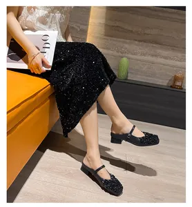 Detailed view of stylish black Mary Jane block heel mules with rhinestone embellishment