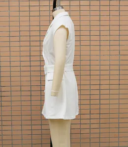 Detailed side view showing the fit of a white sleeveless blazer dress with belt
