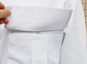 Detailed macro view showing the functional pocket and flap design of this white office blouse