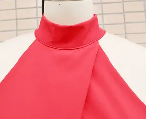 Macro detail view of mock neck and overlapping design on a red sleeveless summer romper