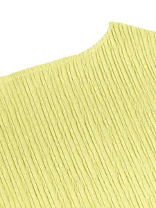 Macro detail of the lemon yellow pleated fabric texture for an elegant summer set