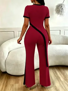 Back view of deep red ribbed two-piece set with asymmetrical black trim and flare pants