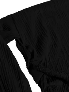 Macro view of the elegant textured black fabric on this stylish one-shoulder top