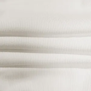 Macro view of high-quality white vertical ribbed knit fabric texture for jumpsuits