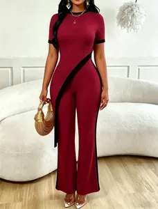 Chic burgundy ribbed two-piece set featuring black contrast diagonal trim and wide-leg pants.